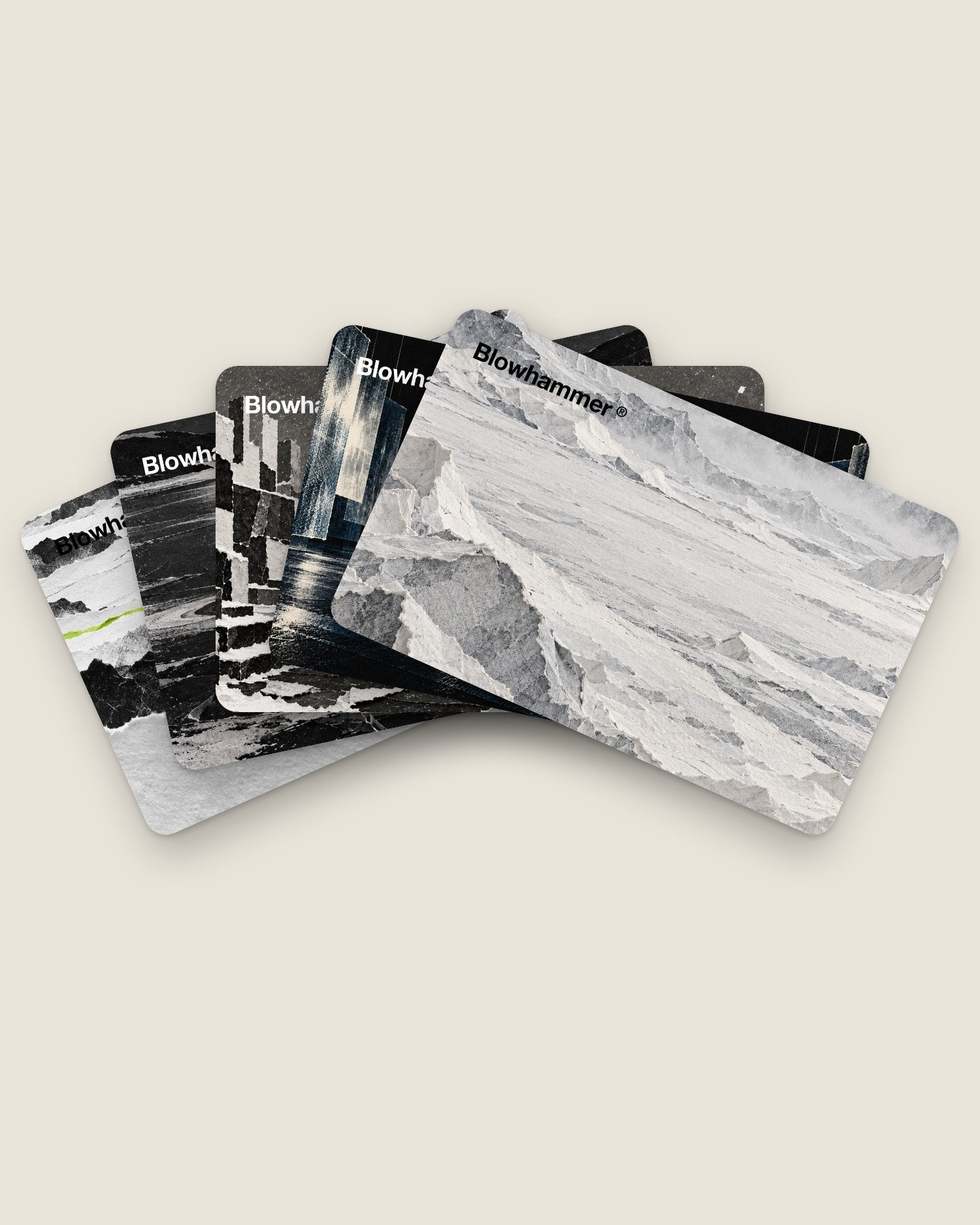 Five Blowhammer gift cards fanned out, each with a different paper world and the logo.