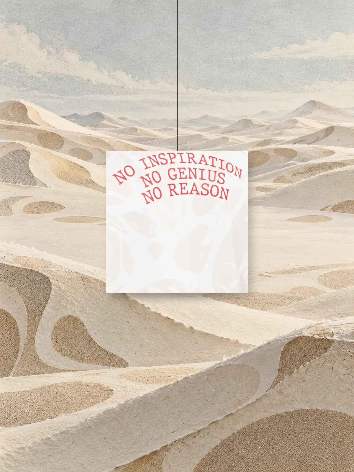 Un quadrato ritagliato dalla stampa della felpa Strand Ivory, con la scritta rossa NO INSPIRATION NO GENIUS NO REASON, appeso a un filo sopra dune di carta avorio.